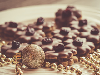 Homemade Christmas sweets with dried cranberries and milk chocolate, gold ornament and golden chain