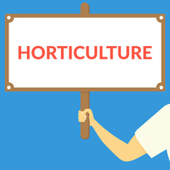 HORTICULTURE. Hand holding wooden sign