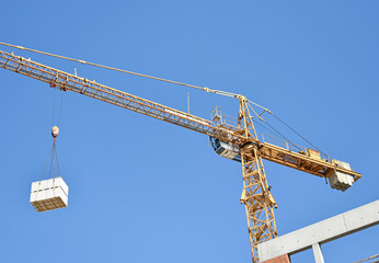 Tower crane works at the construction site
