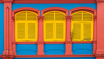 Fototapeta na wymiar Colorful wooden window Colonial style architecture building in Little India, Singapore City.