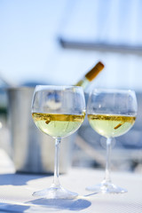 Pair of wineglasses against the yacht