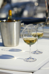 Pair of wineglasses against the yacht