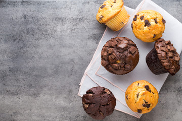 Homemade chocolate muffins on the vintage background.