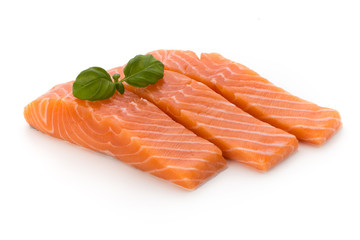 Fresh salmon fillet with basil on the white background.