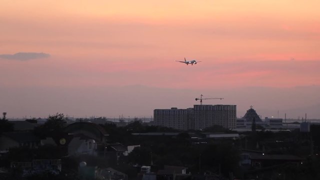 Plane Coming in for a Landing Over Manila in the Philippines During Sunset