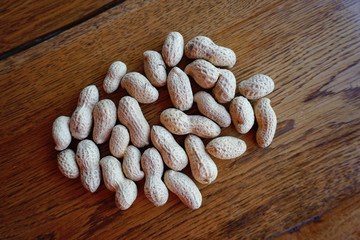 Peanut in a shell on a dark wooden table
