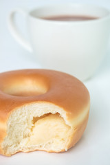 Bite marks on donuts and cup cocoa drink on white background