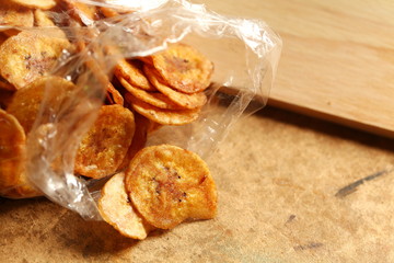 Thin fried crispy banana in plastic bag scene.
