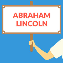 ABRAHAM LINCOLN. Hand holding wooden sign