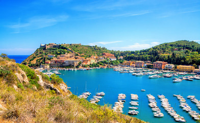 Porto Ercole town,  Monte Argentario, in the Province of Grosseto, Tuscany, Italy. Boats in harbor in a sea bay.