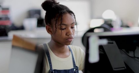 Closeup teenage girl using a computer in class - Powered by Adobe