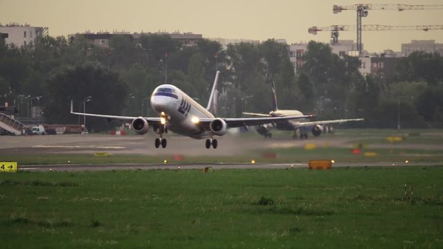 Polish Airways commercial airplanes taxiing and taking off from Warsaw Chopin Airport.