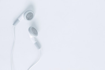 earbuds or earphones top view on white background