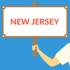 NEW JERSEY. Hand holding wooden sign