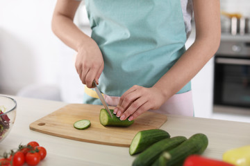 Young woman cooking in kitchen, closeup