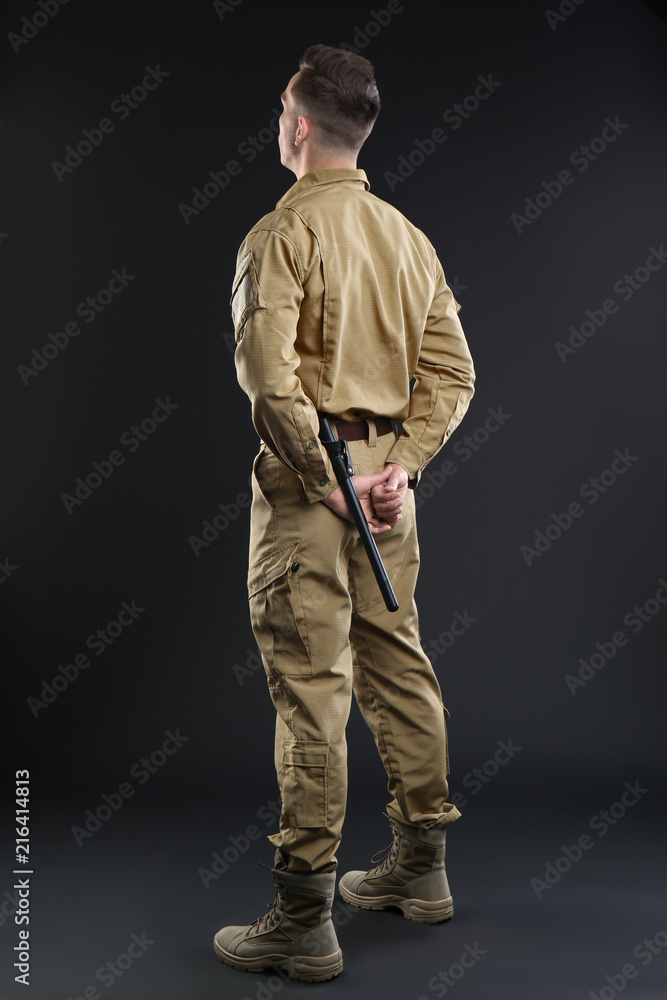 Wall mural Male security guard in uniform on dark background