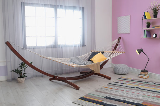 Stylish living room interior with comfortable hammock