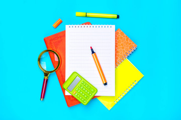 Stationary, back to school,summer time, creativity and education concept.Supplies- scissors, pencils, paper clips,note,stapler and notepad, globe on blue background,flatlay.Mock up.Top view Banner