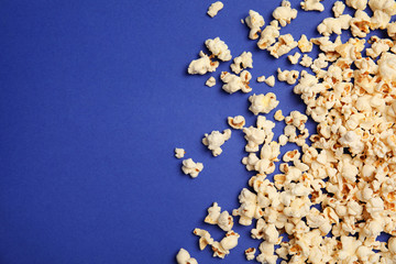 Tasty fresh popcorn on color background, top view