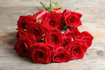 Beautiful red rose flowers on wooden background