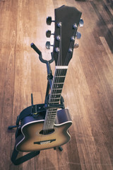 Fototapeta premium close-up and selective focus shot image of acoustic guitar on a wooden background.grain and noise effect