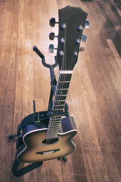 close-up and selective focus shot image of acoustic guitar on a wooden background.grain and noise effect