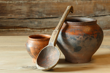 Still life with two pots and a wooden spoon.