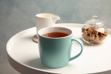 Cup of black tea on round table