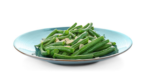 Plate with tasty green beans and almonds on white background