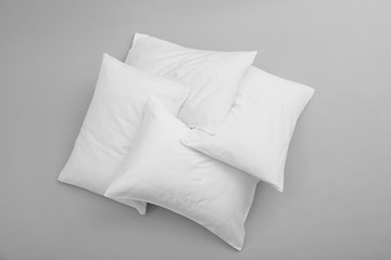Clean soft bed pillows on grey background, top view