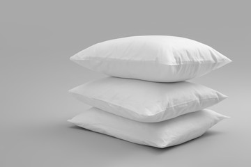Fototapeta na wymiar Clean soft bed pillows on grey background