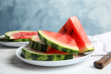 Plate with juicy watermelon slices on table