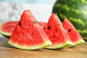 Fresh juicy watermelon slices on wooden table