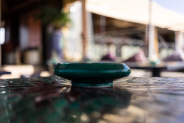 green mosaic table with flower pattern and ashtray