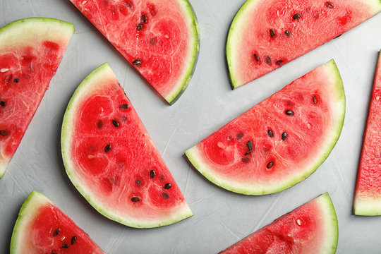 Flat lay composition with watermelon slices on grey background