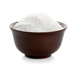 Bowl with baking soda on white background