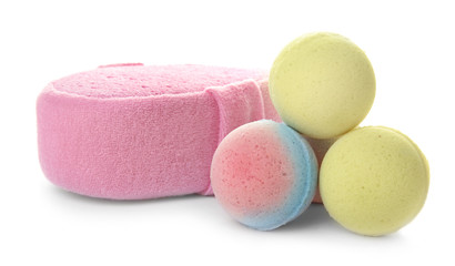 Pink sponge and bath bombs on white background