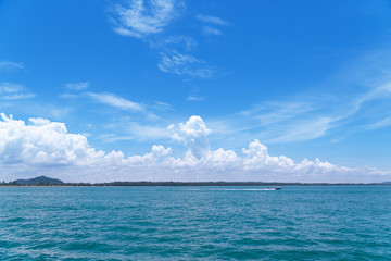 A boat on the sea with blue sky background. Maritime transport.