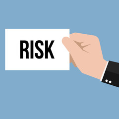 Man showing paper RISK text