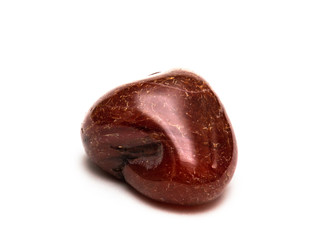 Carnelian is a brownish-red mineral commonly used as a semi-precious gemstone. Isolated on white background