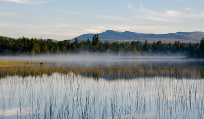 misty mountain lake in morning light