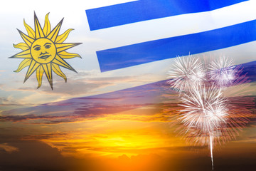 Uruguay independence day, 25th August, double exposure of Uruguay flag and sunset sky with fireworks