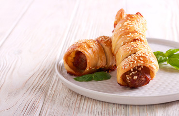 Sausage rolls with sesame on top,