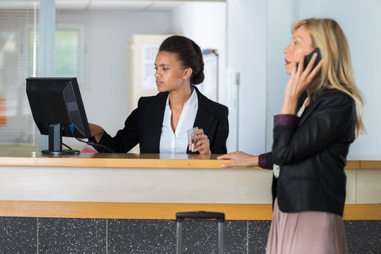 customer on telephone at hotel reception