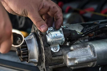 Foto op Canvas Mechanics with dirty hands repair broken starter on car/ Automotive service © Moab Republic