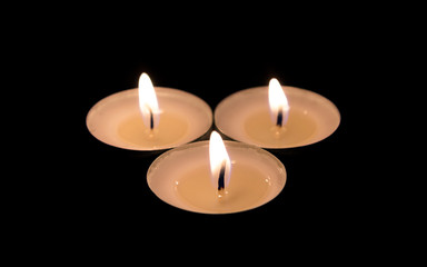 Three Burning Candles in Darkness