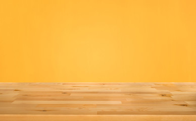 Empty wood table top on yellow color background