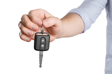 Male hand holding car key, isolated on white background