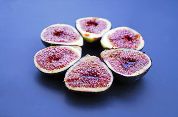 Fresh figs on dark blue background. Beautiful blue violet figs with as close up..