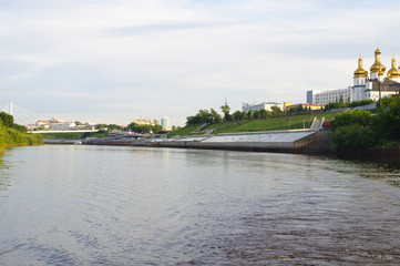 Fototapeta premium Tura River Embankment in Tyumen, Russia. Holy Trinity Monastery.